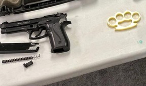 A cache of weapons, including an EKOL Jackal Dual 9mm Blank handgun and set of brass knuckles, were seized by Windsor police on Friday, and two suspects have been arrested and charged following an investigation in east Windsor.