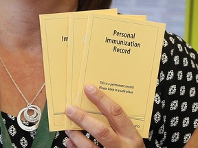 Personal Ontario immunization cards are shown in this file photo.