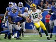 Aaron Rodgers of the Green Bay Packers runs with the ball in the fourth quarter of a game against the Detroit Lions.