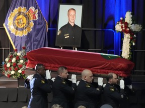 Pallbearers carry the casket of OPP Const. Grzegorz (Greg) Pierzchala after his funeral service at the Sadlon Arena in Barrie, Ont., Wednesday, Jan.4, 2023.