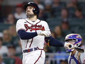 Adam Duvall of the Atlanta Braves watches after hitting a two run home run during the seventh inning against the New York Mets at Truist Park on July 12, 2022 in Atlanta, Georgia.