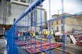 Construction workers gather after a construction site accident at 131 King Street in London on Thursday January 5, 2023. (Derek Ruttan/The London Free Press)