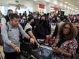 Sunwing passengers line up for check-in at Cancun International Airport on Dec. 27, 2022, after many flights to Canada had been cancelled due to severe winter weather.