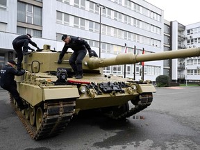 Members of the military walk on a tank, as Germany delivers its first Leopard tanks to Slovakia as part of a deal after Slovakia donated fighting vehicles to Ukraine, in Bratislava, Slovakia, December 19, 2022.