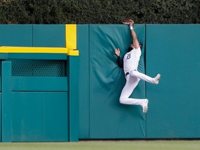 Detroit Tigers center fielder Derek Hill makes a leaping catch at the wall for an out against Seattle Mariners third baseman Kyle Seager (not pictured) during the first inning at Comerica Park.