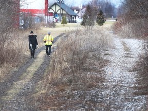 Susan and Wayne Robson walk their dog along the former Canada Southern Railway tracks in Essex on Friday, Jan. 20, 2023.