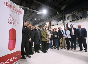 Dignitaries and employees are shown Monday at the CapsCanada plant in Lakeshore after a press conference announcing federal funding for the company.