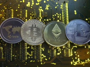 Representations of cryptocurrency are shown in this photo illustration.