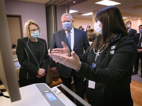 Ontario's Deputy Premier and Minister of Health Sylvia Jones, left, and Premier Doug Ford speak with Casey Kouvelas, clinical practice manager at Windsor Regional Hospital Met campus on Thursday, Jan. 19, 2023.