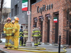 Windsor firefighters stand outside Capitano - a restaurant in the 700 block of Erie Street East - on the morning of Jan. 20, 2023.