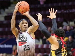 WINDSOR, ON. JANUARY 27, 2023 - Billy White, left, of the Windsor Express pulls up for a jumper over DaRohn Scott of the Sudbury Five on Friday, January 27, 2023 at the WFCU Centre in Windsor.