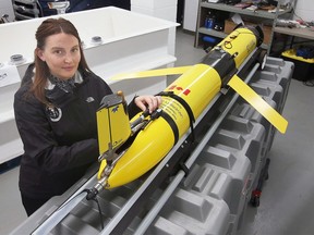 Katelynn Johnson, research and operations director with RAEON at the University of Windsor is shown with a slocum glider on Friday, January 6, 2023. The device operates autonomously underwater to collect data 24/7 for Great Lakes scientists.