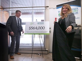 Richard Wyma, Chair of the WindsorEssex Community Foundation and Mila Lucio, Executive Vice President, Head of Human Resources and Social Impact at Green Shield Canada unveil a ceremonial cheque for $564,000 on Tuesday, January 24, 2023. Green Shield made the donation to support local organizations that provide mental and oral health care.