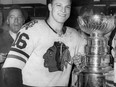 In this April 16, 1961, file photo, Chicago Blackhawks hockey player Bobby Hull smiles in the dressing room beside the Stanley Cup after Chicago defeated the Detroit Red Wings, 5-1, to win the NHL Championship, in Detroit. THE CANADIAN PRESS/AP