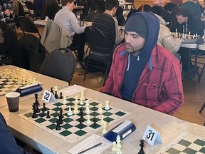 Joey Votto playing chess at Toronto's Annex Chess Club.