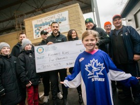 Avaleigh Stradeski, 9, front, is pictured during a cheque donation from the St. Clair College Alumni Association to the Knobby's Kids, at Lanspeary Park, on Saturday, Jan. 21, 2023.