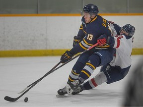 University of Windsor Lancer's forward Sean Olson gets in front of the Brock Badgers' Cole Thiessen for a scoring opportunity during Saturday's OUA men's hockey game at the Capri Recreation Complex.