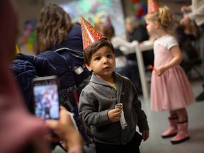 Adam Ibrahim, 1, gets his photo taken by mom at the Riverside Public Library where an early New Year’s Eve party was held for families with young children, on Saturday, Dec. 31, 2022.