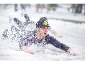 Staff and students at St. Clair College take part in a wintery slip n? slide for the campaign launch of the 9th Annual Polar Plunge Windsor-Essex, at St. Clair College, on Wednesday, Jan. 25, 2023.