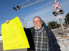John West, a resident of South Walkerville, is pictured at the rail crossing on Kildare Road, on Tuesday, Jan. 31, 2023.  West is upset with the Essex Terminal Railway for the increase in train whistles that he says disrupt his sleep.
