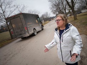 Beth Higgins, whose house sits on a private road owned by Country Village nursing home, and alleges the nursing home isn't maintaining the road, is pictured outside her home, on Thursday, Jan. 12, 2023.
