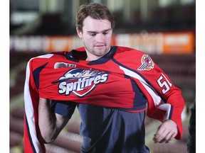 Newly acquired Windsor Spitfire Shane Wright puts on a team jersey at the WFCU Centre on Tuesday.