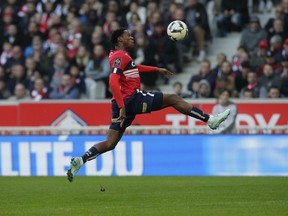 Thanks to a two-goal performance against Troyes, Canadian forward Jonathan David has become the first foreign player to reach 40 goals with Lille in France's Ligue 1. David controls the ball in the air during the French League One match Lille against Angers at the Pierre Mauroy stadium Sunday, Nov. 13, 2022 in Lille, northern France.