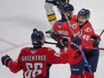 Recently acquired Windsor Spitfires' defenceman Rodwin Dionicio, centre, celebrates a goal during Thursday's win over Erie with teammates Liam Greentree, at left, and Alex Christopoulos.
