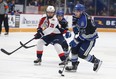 Sudbury Wolves forward Nathan Villeneuve, right, attempts to skate past Windsor Spitfires' forward Nick Graniero during Friday's game in Sudbury. John Lappa/Sudbury Star/Postmedia Network