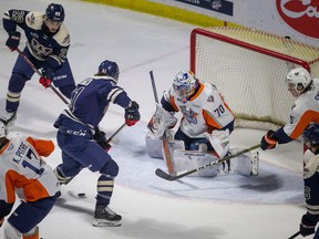 WINDSOR, ONT:. JANUARY 8 - Windsor's Colton Smith misses on a scoring opportunity against Flint goaltender, Will Cranley,  in OHL action between the Windsor Spitfires and the Flint Firebirds at the WFCU Centre, on Sunday, January 8, 2023.