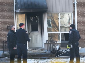 Investigators with Windsor Police and Windsor Fire are shown at the scene of a townhouse fire near McDougall and Wyandotte on Tuesday, January 24, 2023.
