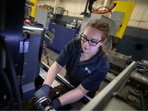 Cynthia Cooper works on an EDM at Cavalier Tool & Manufacturing Ltd., on Friday, Jan. 20, 2023.