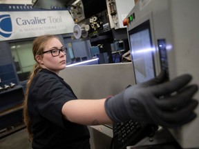 Cynthia Cooper works on an EDM at Cavalier Tool & Manufacturing Ltd., on Friday, Jan. 20, 2023.