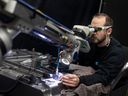 Eric Caron works on a laser welder at Cavalier Tool & Manufacturing Ltd, on Friday, Jan. 20, 2023.