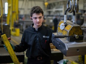 Aidan Savoie, a toolmaker at Cavalier Tool & Manufacturing Ltd., works on the plant floor on Friday, Jan. 20, 2023.