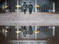 Large puddles from snow melt and rain cover Charles Clark Square as they reflect a promenade sculpture in front of city hall on Jan. 1, 2023.
