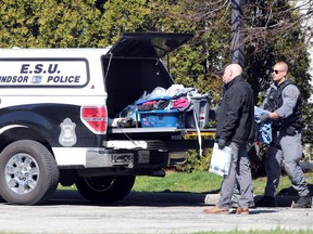 Windsor Police ESU members and detectives gather evidence at the rear of Motel 6 on Huron Church road following a homicide nearby on Northway Avenue.