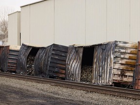 Charred train cars sit near railroad tracks in East Palestine, Ohio, Tuesday, Feb. 14, 2023. The Norfolk Southern train derailed on Feb. 3, releasing toxic fumes and forcing the evacuation of residents.