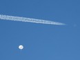 A jet flies by a suspected Chinese spy balloon as it floats off the coast in Surfside Beach, South Carolina, Saturday, Feb. 4, 2023.