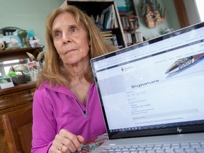 Retired University of Windsor professor, Victoria Paraschack, is pictured with an online petition for a judicial review of abuse in Canadian sport, on Tuesday, Feb. 21, 2023.
