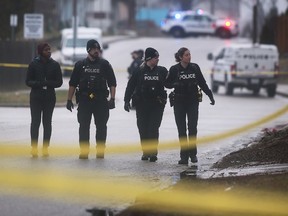 Windsor police officers search the area of Marentette Avenue north of Wyandotte Street East following a stabbing incident on Brant Street on Feb. 9, 2023.