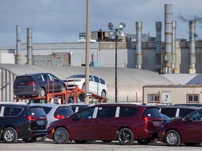 Chrysler Pacificas are loaded onto a transport truck outside the Windsor Assembly Plant on Friday, Feb. 3, 2023.