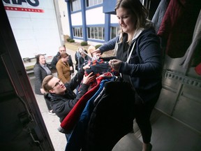 River Schauber , left, and Lauren Dobson, employees with Cintas in Windsor load coats on Thursday, February 16, 2023 for the Unemployed Help Centre Hub of Opportunities Coats for Kids Initiative.