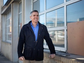 Rhys Trenhaile is pictured outside 493 University Avenue West, which he owns and is converting into a mix-use with six residential units, on Tuesday, Feb. 7, 2023.