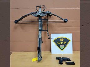 A crossbow and a firearm seized by Essex County OPP during a raid in the town of Essex on Jan. 31, 2023.