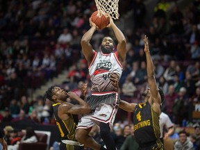 Windsor Express forward Kobie Williams drives to the basket while being defended by London's Mike Nuga, left, and Jeremiah Mordi during Monday's NBL of Canada game at the WFCU Centre.