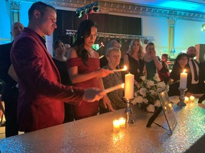 Family members light candles for lost loved ones at the 25th anniversary In Honour of the Ones We Love gala, Feb. 4, 2023, at the Ciociaro Club.