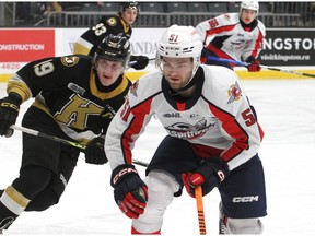Windsor Spitfires centre and former Kingston Frontenac Shane Wright, right, looks for the puck as Kingston's Paul Ludwinski pursues during Sunday's game at the Leon's Centre. Ian MacAlpine/Kingston Whig-Standard/Postmedia Network