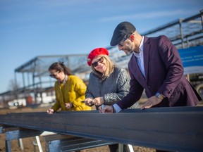 From left, the Greater Essex County District School Board Director of Education, Erin Kelly,Trustee Julie Burgess, and Superintendent of Education, Josh Canty, sign the last steel beam to be used in the construction of the new Kingsville District High School on Jasperson Drive in Kingsville, on Tuesday, Feb.14, 2023.