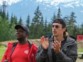 Former NFL athlete Luke Willson (right) and champion sprinter Donovan Bailey (left) watch their teams compete on the set of the reality TV show Canada's Ultimate Challenge.
